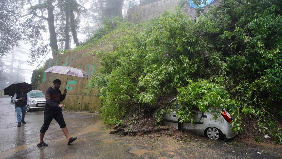 A parked vehicle buried under the debris after a landslide near Chaura Maidan in Shimla on Monday. (Deepak Sansta/HT) A parked vehicle buried under the debris after a landslide near Chaura Maidan in Shimla on Monday. (Deepak Sansta/HT)
