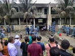 Onlookers gathered as Bangladesh Air Force personnel inspect the crash site a day after a training jet crashed into a school in Dhaka on July 22, 2025. Onlookers gathered as Bangladesh Air Force personnel inspect the crash site a day after a training jet crashed into a school in Dhaka on July 22, 2025.