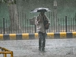 A pedestrian uses an umbrella while crossing a street during rainfall in New Delhi on July 22, 2025. A pedestrian uses an umbrella while crossing a street during rainfall in New Delhi on July 22, 2025.