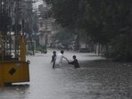 People wade through the flooded street after during the monssoon rain in Rawalpindi, Pakistan on July 17, 2025. 