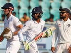 Haseeb Hameed (centre) runs with Alastair Cook (left) as Virat Kohli looks on