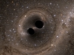 The collision of two black holes is seen in this still image from a computer simulation.
