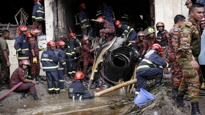 Firefighters work to remove the wreckage from a building in the Milestone College campus in Dhaka where the Bangladesh air force jet crashed. (REUTERS)