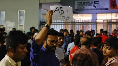 A volunteer blood donor holding a placard as he wants to donate AB(+) to the victims if needed, in front of the hospital where the injured are being treated. (REUTERS)