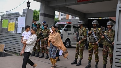Law enforcement officers stand guard at the entrance of the National Institute of Burn and Plastic Surgery as survivors are treated inside. Most of the people who sustained injuries are being treated at the NIBPS in Dhaka. (AP) Law enforcement officers stand guard at the entrance of the National Institute of Burn and Plastic Surgery as survivors are treated inside. Most of the people who sustained injuries are being treated at the NIBPS in Dhaka. (AP)
