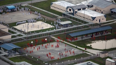At a Miami immigration detention center, migrants were held in cells for hours without lunch and remained shackled while eating around 7 p.m. (Getty Images via AFP) At a Miami immigration detention center, migrants were held in cells for hours without lunch and remained shackled while eating around 7 p.m. (Getty Images via AFP)