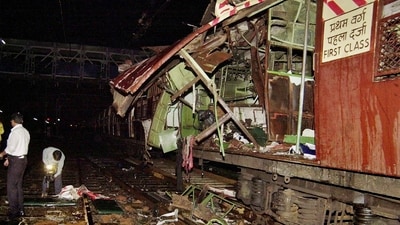 In this July 11, 2006 file photo, policemen investigate near a train coach destroyed by a bomb blast at Matunga railway station in Mumbai. (PTI)