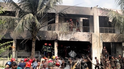 Bangladesh's fire service and security personnel conduct a search and rescue operation after the Air Force jet crashed. Most of the 27 people killed were students at the Milestone College. (AFP) Bangladesh's fire service and security personnel conduct a search and rescue operation after the Air Force jet crashed. Most of the 27 people killed were students at the Milestone College. (AFP)