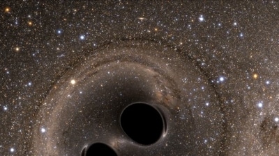 The collision of two black holes is seen in this still image from a computer simulation. The collision of two black holes is seen in this still image from a computer simulation.