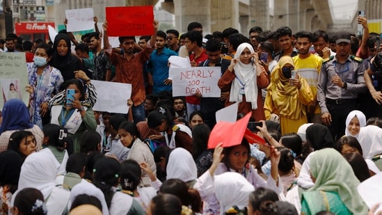 Students of the Milestone College hold placards as they protest, demanding revelation of actual number of death toll in the Airforce jet crash in Dhaka(REUTERS)