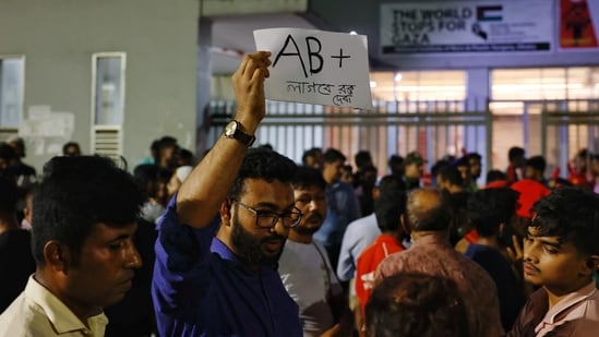 A volunteer blood donor holding a placard as he wants to donate AB(+) to the victims if needed, in front of the hospital where the injured are being treated.(REUTERS)