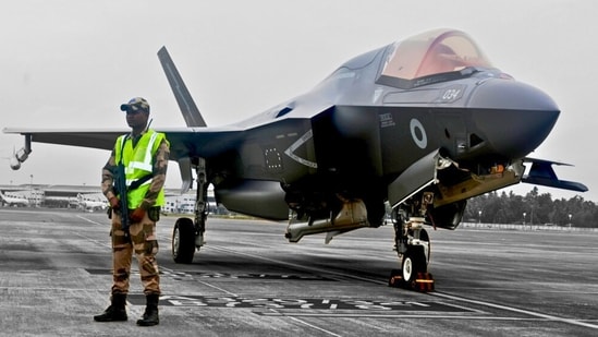 A CISF personnel stands guard near the British F-35 fighter jet that made an emergency landing after running low on fuel at the Thiruvananthapuram International Airport on June 14, 2025. (X/CISFHQrs)