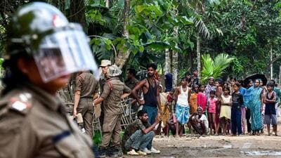 Security personnel stand guard as villagers watch the demolition of their houses by local authorities during an eviction drive at an alleged illegal residential settlement inside the Paikan Reserve Forest in Goalpara district, in Assam (AFP FILE) Security personnel stand guard as villagers watch the demolition of their houses by local authorities during an eviction drive at an alleged illegal residential settlement inside the Paikan Reserve Forest in Goalpara district, in Assam (AFP FILE)