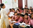 A teacher teaching students at a government-run upper primary school in Prayagraj. (HT file)