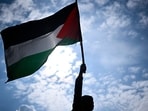 A protester holds a Palestinian flag during a rally called by several French organisations in support of Palestinian people at Place de la Republique in Paris. A protester holds a Palestinian flag during a rally called by several French organisations in support of Palestinian people at Place de la Republique in Paris.