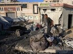A Palestinian man inspects the damage at the site of an overnight Israeli strike on a tent sheltering displaced people.