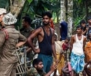 Security personnel stand guard during an eviction drive in Assam. (AFP)