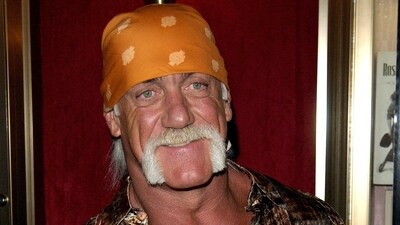 Wrestler and body builder Hulk Hogan poses for photographers after arriving for the US premiere of the film "War of the Worlds," (REUTERS)