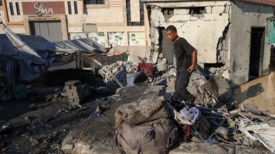 A Palestinian man inspects the damage at the site of an overnight Israeli strike on a tent sheltering displaced people. (REUTERS)