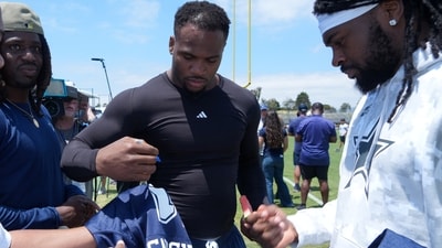 Dallas Cowboys defensive end Micah Parsons (left) and cornerback Trevon Diggs sign autographs (IMAGN IMAGES via Reuters Connect)