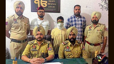 Police officials with the arrested man on Thursday. (HT Photo)