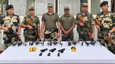 The cache of arms and heroin seized by the BSF. The cache of arms and heroin seized by the BSF.