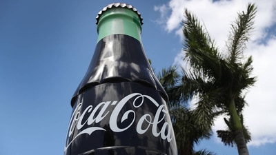 A Coca Cola bottle is seen in front of a distribution in Florida. A Coca Cola bottle is seen in front of a distribution in Florida.