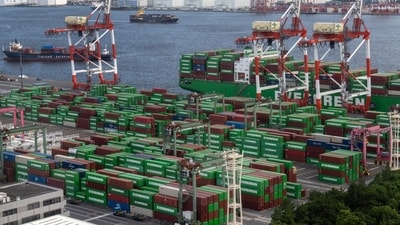 Containers are stacked at a shipping terminal in Tokyo. Containers are stacked at a shipping terminal in Tokyo.