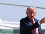 US President Donald Trump gestures after disembarking Marine One, as he departs for Scotland.