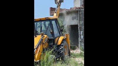 Demolition of a house, belonging to a ‘drug peddler’, underway in Malakpur village of Ludhiana on Friday. (HT Photo)