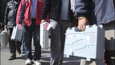 Election officials carry EVMs from a distribution centre in Amritsar. AFP
