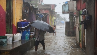 People in slum areas were seen wading through the waterlogged roads as rain continued to pound Mumbai. (Reuters)