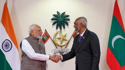 Mohamed Muizzu (R), shakes hand with PM Modi after signing a memorandum of understanding between the two countries in Male. (AP)