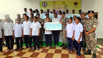 Inspector General of Police (Bastar Range) Sundarraj P hands over a cheque to Maoists after their surrender, in Bijapur district, on Thursday. (PTI) Inspector General of Police (Bastar Range) Sundarraj P hands over a cheque to Maoists after their surrender, in Bijapur district, on Thursday. (PTI)
