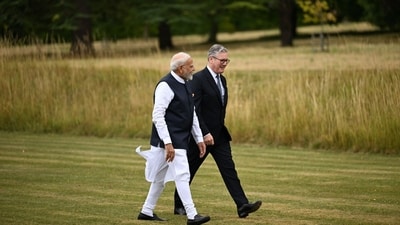 Keir Starmer and Narendra Modi exchange conversations as both walk on the grounds of Chequers near Aylesbury, UK. (Chris J. Ratcliffe/Bloomberg) Keir Starmer and Narendra Modi exchange conversations as both walk on the grounds of Chequers near Aylesbury, UK. (Chris J. Ratcliffe/Bloomberg)