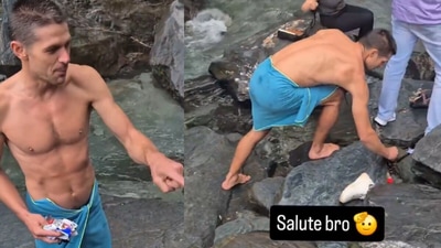 In a video from a scenic Kangra waterfall, a foreign tourist is seen picking up plastic wrappers left by visitors. (@iNikhilsaini/X) In a video from a scenic Kangra waterfall, a foreign tourist is seen picking up plastic wrappers left by visitors. (@iNikhilsaini/X)