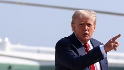 US President Donald Trump gestures after disembarking Marine One, as he departs for Scotland. (REUTERS)