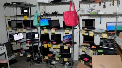 A photograph of the ‘laptop farm’ in Christina Chapman’s residence, taken during a law enforcement raid and filed in a sentencing memorandum. A photograph of the ‘laptop farm’ in Christina Chapman’s residence, taken during a law enforcement raid and filed in a sentencing memorandum.