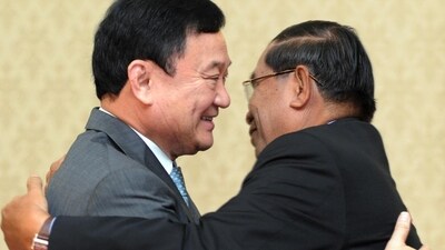 Former Thai Prime Minister Thaksin Shinawatra, in gray, hugs Cambodian Prime Minister Hun Sen in 2011. Former Thai Prime Minister Thaksin Shinawatra, in gray, hugs Cambodian Prime Minister Hun Sen in 2011.