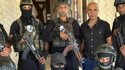 Mr. Shabab, center, poses with members of his Popular Forces militia in Rafah. Mr. Shabab, center, poses with members of his Popular Forces militia in Rafah.
