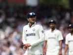 India's captain Shubman Gill (L) leads his team off the field at the end of the first innings on day four of the fourth cricket test match between England and India at Old Trafford, in Manchester