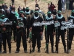 Hamas militants gather at the site of the handing over of the bodies of four Israeli hostages in Khan Yunis in southern Gaza on February 20, 2025 Hamas militants gather at the site of the handing over of the bodies of four Israeli hostages in Khan Yunis in southern Gaza on February 20, 2025