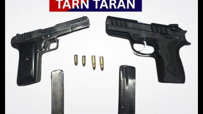 A Glock pistol and a .32-bore pistol with magazines and ammo seized