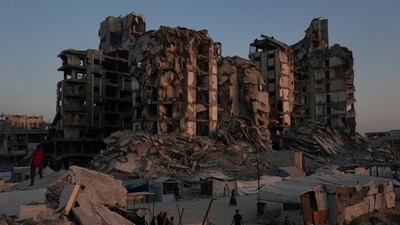Palestinians at a tent camp next to buildings destroyed in Israeli military operations in Gaza City, July 25. (AP) Palestinians at a tent camp next to buildings destroyed in Israeli military operations in Gaza City, July 25. (AP)