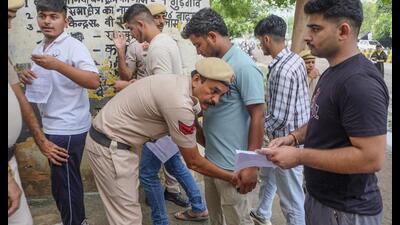 Aspirants undergo frisking before they appear for the Haryana Staff Selection Commission common eligibility test in Gurugram on Saturday. (PTI) Aspirants undergo frisking before they appear for the Haryana Staff Selection Commission common eligibility test in Gurugram on Saturday. (PTI)