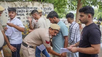 Aspirants undergo frisking before they appear for the Haryana Staff Selection Commission (HSSC) Common Eligibility Test (CET) 2025 in Gurugram on Saturday. (PTI) Aspirants undergo frisking before they appear for the Haryana Staff Selection Commission (HSSC) Common Eligibility Test (CET) 2025 in Gurugram on Saturday. (PTI)