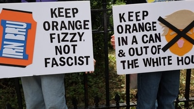 Demonstrators hold placards reading 'Keep orange fizzy, not fascist' outside the US Consulate building in Edinburgh, Scotland on July 26, 2025. (AFP) Demonstrators hold placards reading 'Keep orange fizzy, not fascist' outside the US Consulate building in Edinburgh, Scotland on July 26, 2025. (AFP)
