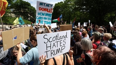 Demonstrators hold placards reading ‘Scotland hates Trump’ near the US Consulate building in Edinburgh, Scotland on July 26, 2025. (AFP) Demonstrators hold placards reading ‘Scotland hates Trump’ near the US Consulate building in Edinburgh, Scotland on July 26, 2025. (AFP)