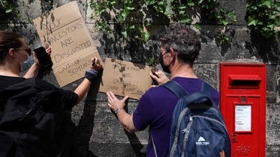 Demonstrators write on cardboard during a 'Stop Trump Coalition' protest near the US Consulate building in Edinburgh, Scotland on July 26, 2025. (AFP) Demonstrators write on cardboard during a 'Stop Trump Coalition' protest near the US Consulate building in Edinburgh, Scotland on July 26, 2025. (AFP)