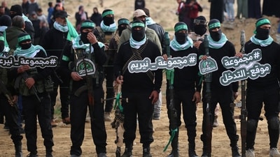 Hamas militants gather at the site of the handing over of the bodies of four Israeli hostages in Khan Yunis in southern Gaza on February 20, 2025 (AFP/) Hamas militants gather at the site of the handing over of the bodies of four Israeli hostages in Khan Yunis in southern Gaza on February 20, 2025 (AFP/)